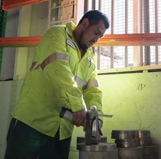 Technician using x-ray fluorescence scanner to verify the chemical composition of heat-resistant superalloys.