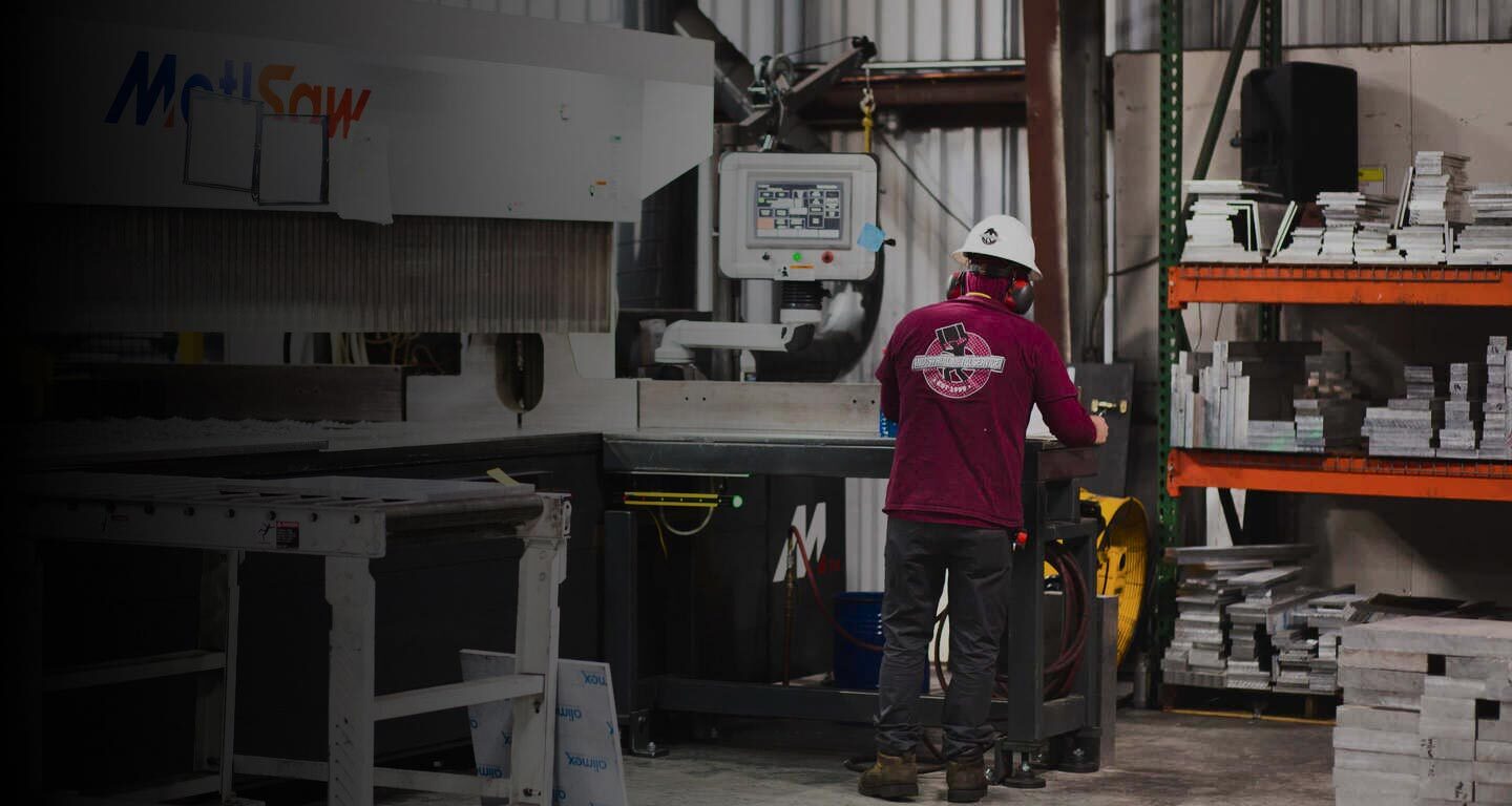 man handling a metal cutting machine