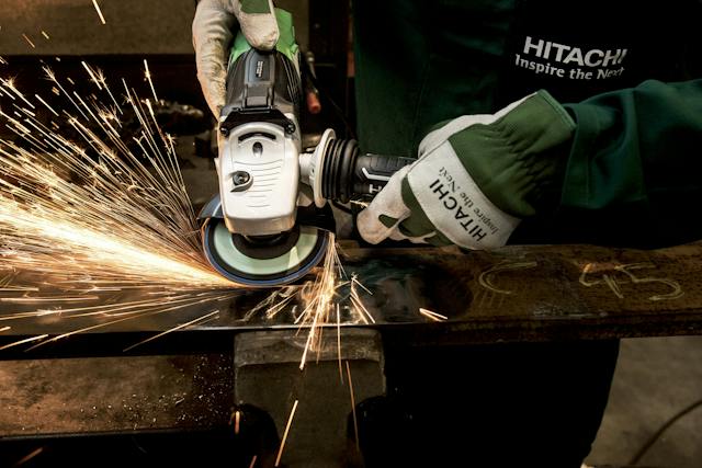 Person using angle grinder on metal