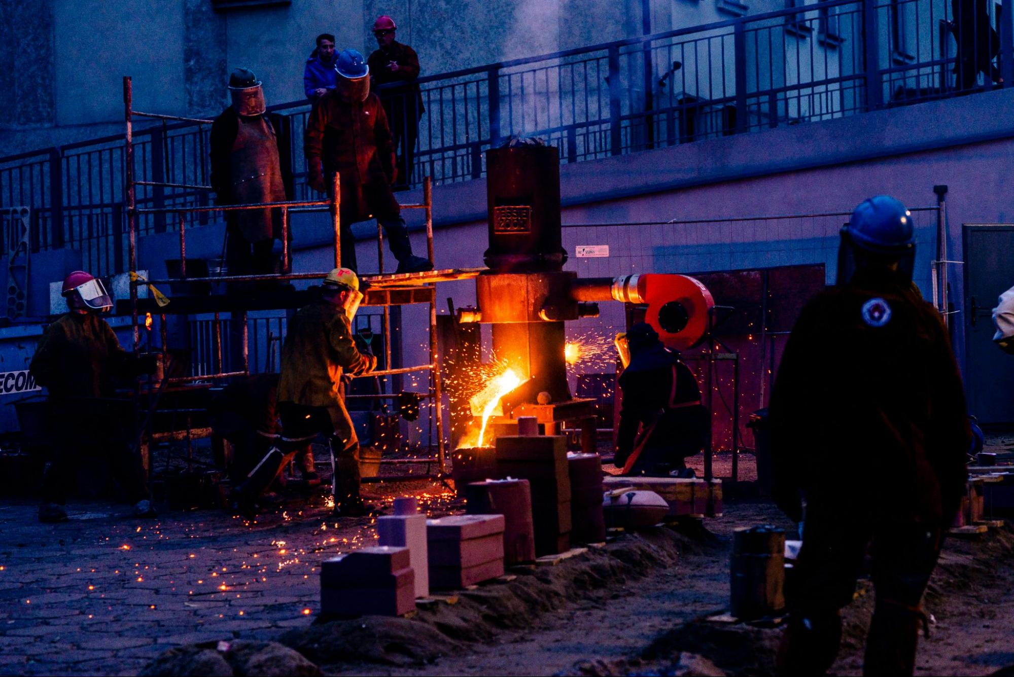 metal foundry workers casting molten metal