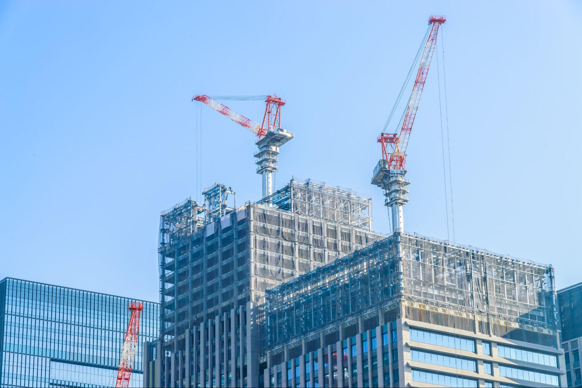 construction cranes at a building site during the day