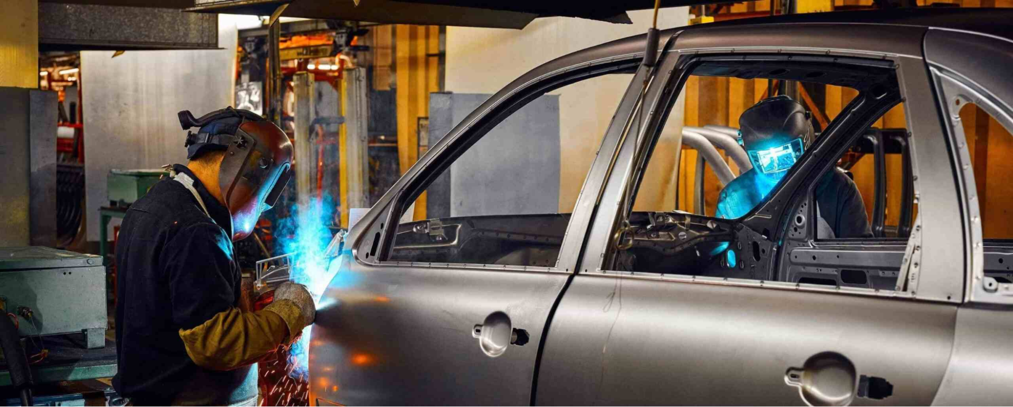 man welding a car